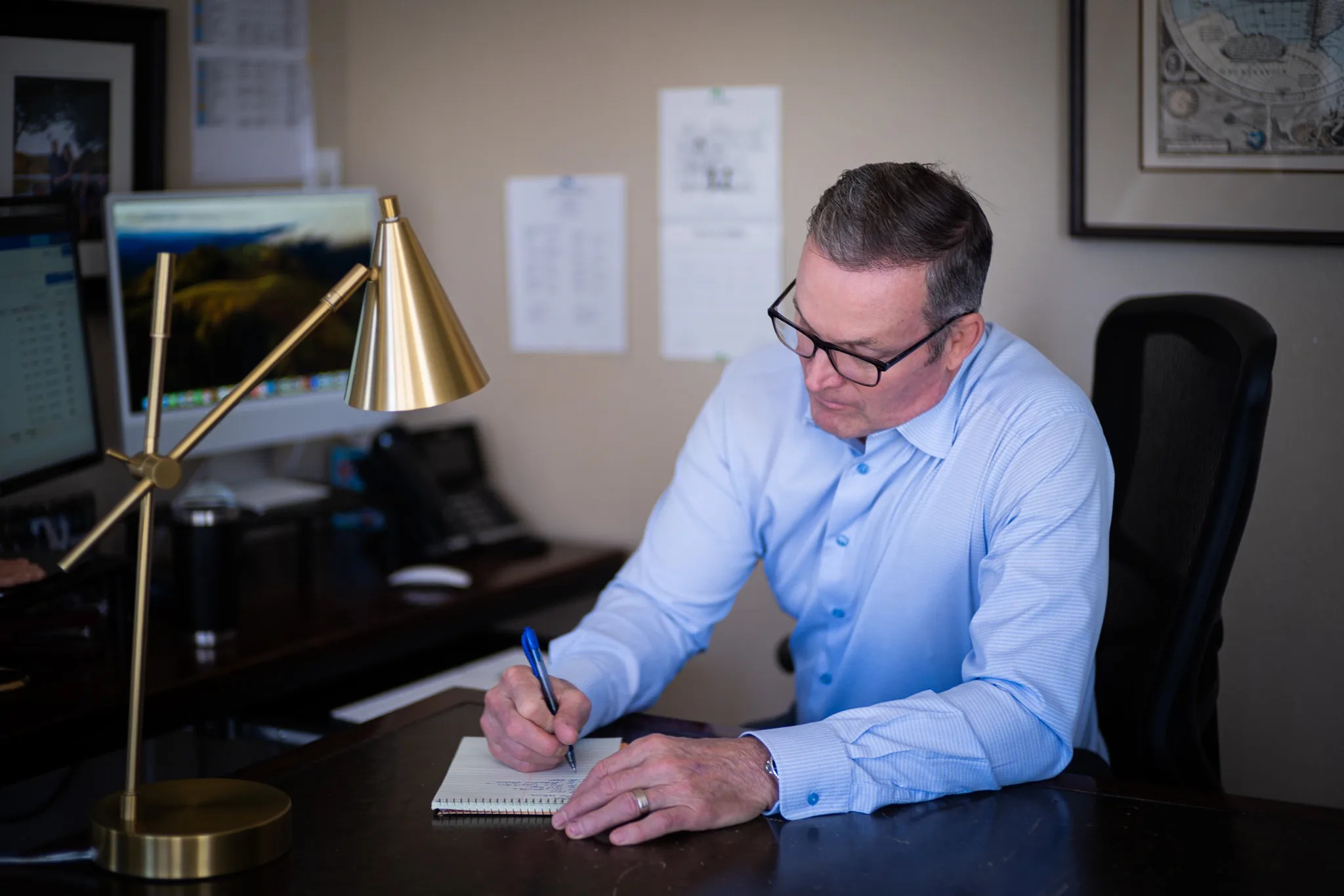 An attorney at Nelson Law Firm at work in his office, photographed by UPWARD